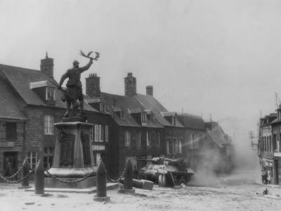 M10 Tank Destroyer passes WWI Memorial in Lonlay-l’Abbaye, 1944