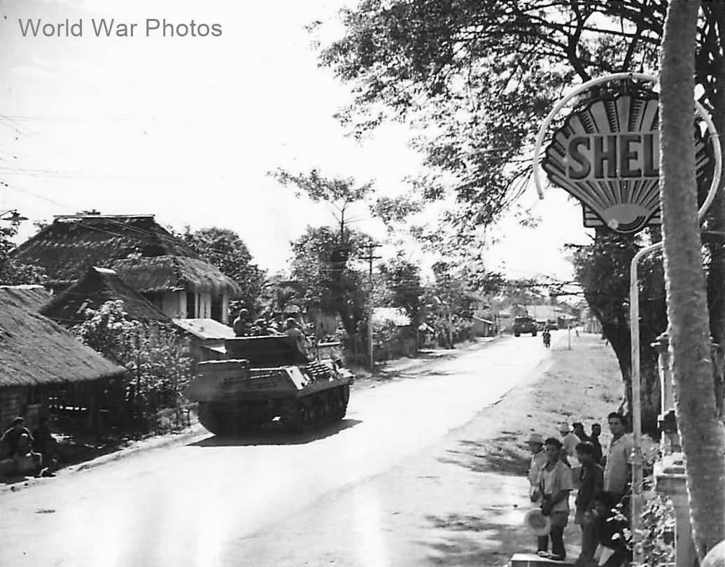M10 heading to Clark Field passes Shell Oil Sign on Luzon 1945