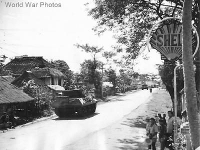 M10 heading to Clark Field passes Shell Oil Sign on Luzon 1945