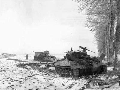 Destroyed M18 and M15 Halftrack in the background. Bastogne, December 29, 1944