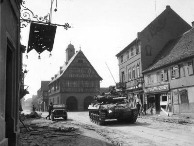 M18 Hellcat and troops of the 3rd Army move thru Gros Gerau, Germany, 1945