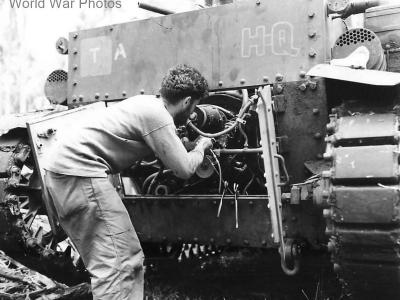 Marine tank crewman checks M2A4 engine on Guadalcanal 1942