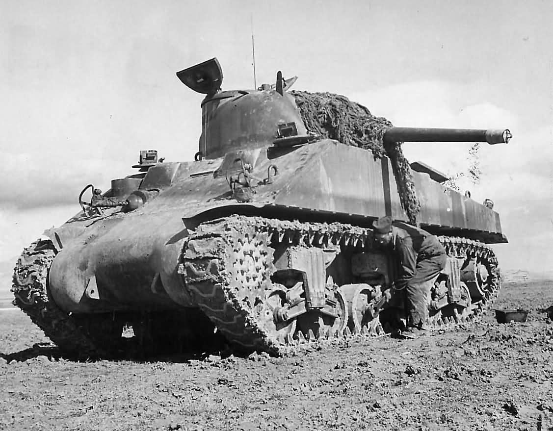 Crewman Adjusts Boggie Wheel on M4 Sherman Tank in Tunisia 1943