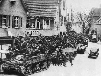 US 7th Army Troops and M4 Sherman Tanks Move thru Captured German Town