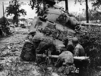 German Fallschirmjager with a Panzerschreck hiding behind a M4 Sherman