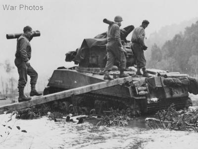 Soldiers bridge flood waters to keep M4 tank firing France, 7th Army