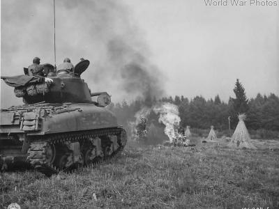 Flame throwing tank M4A1(76)W blasts haystack in Belgium 1944