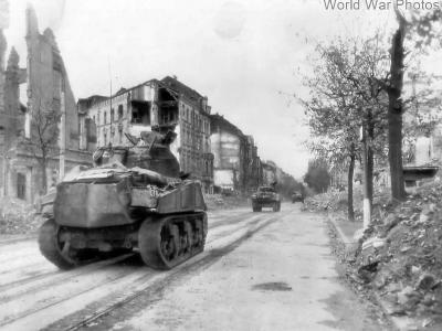 Shermans moving thru streets of Aachen