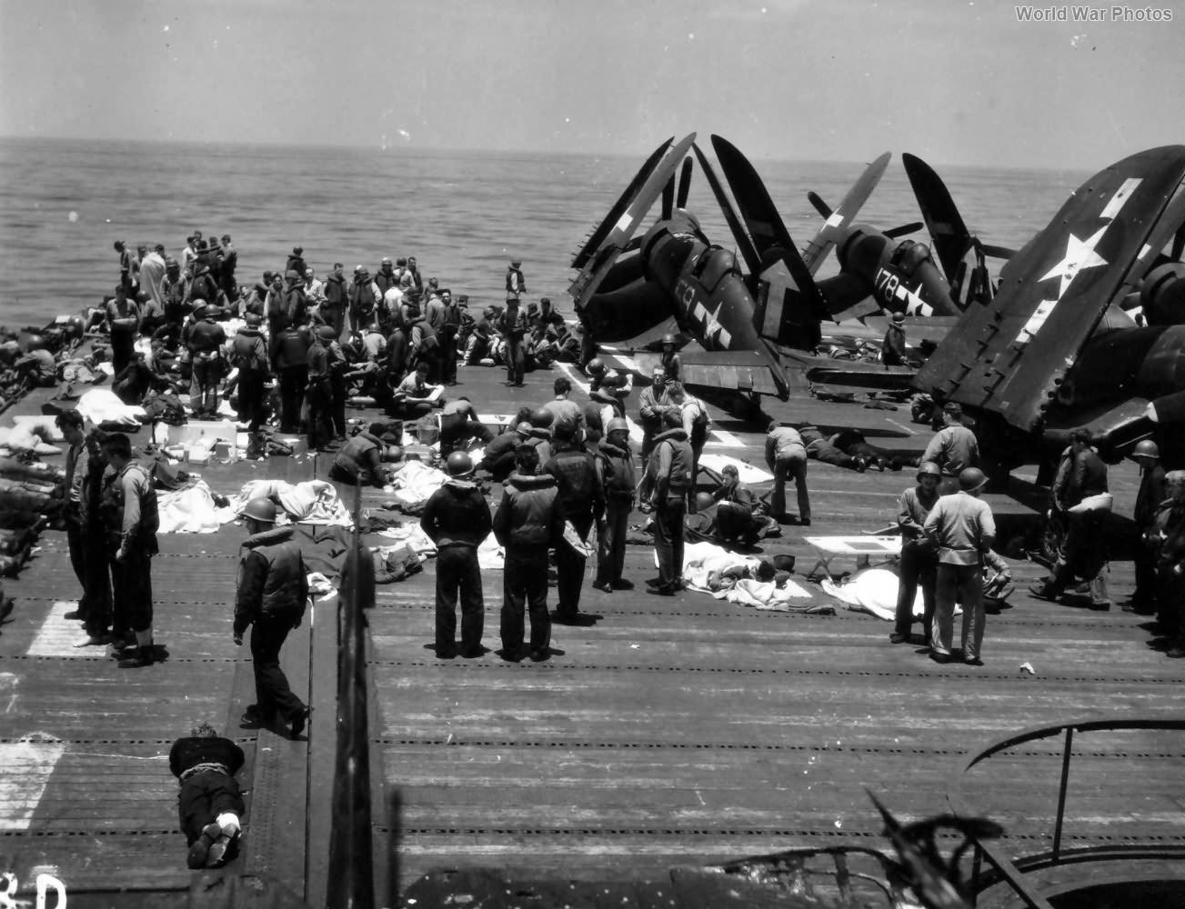 Wounded sailors are treated on the flight deck of the USS Bunker Hill
