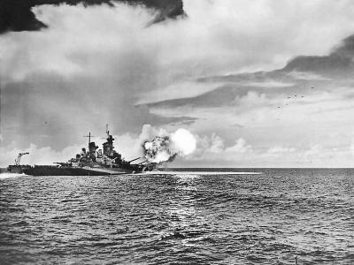 Projectiles in air as USS Missouri (BB-63) fires 406 mm (16 in) guns
