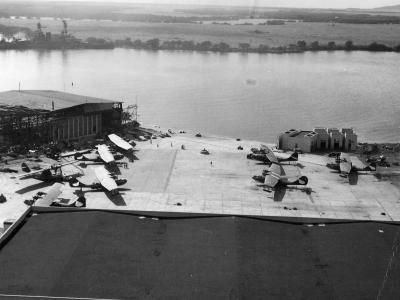 PBY at NAS Ford Island battleship USS Nevada (BB-36) aground in the background