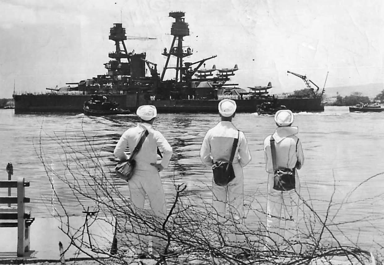Sailors watch repaired Battleship USS Nevada leave Pearl Harbor 1942
