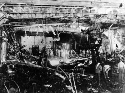 Wreckage on hangar deck escort carrier USS Sangamon after a kamikaze attack