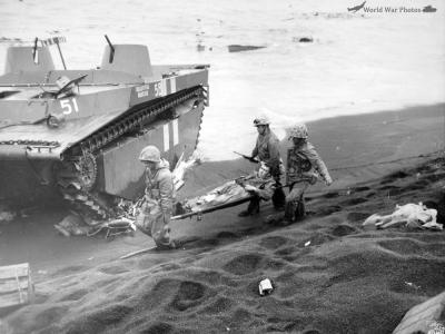 Marines carry a wounded comrade to an evacuation point on Iwo Jima beachhead