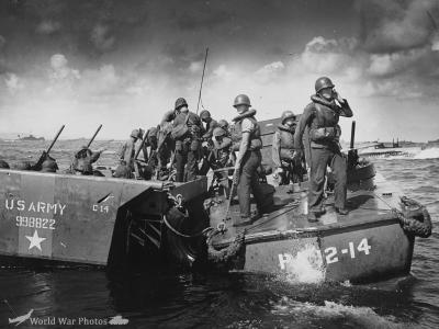 Smashed by a direct hit from Jap shore batteries at Saipan an Army amtrac is sinking