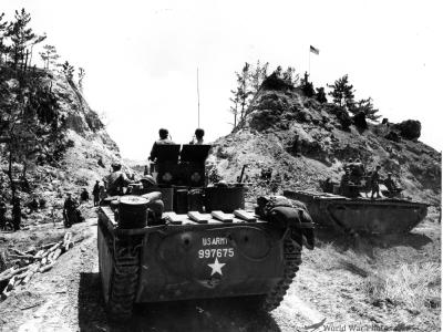 Troops of 96th Division pause at the pass leading to Chatan village Okinawa