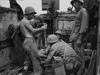 Wounded Marine receives treatment aboard an LVT at Peleliu
