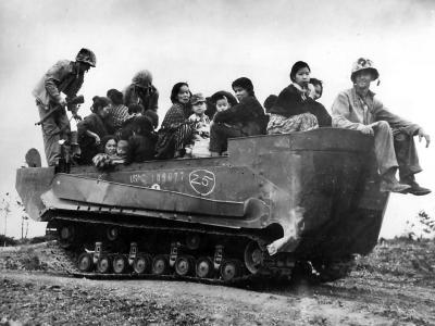Marines carry women and children To Safety in M29C Weasel on Okinawa, 1945