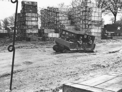 Troops in M29 Weasel at ordnance depot in France