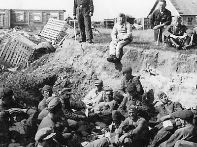 Battered Russian POWs gathered in ditch by Wehrmacht captors