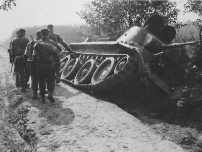 Soviet tank BT-7 lying on its side in a ditch